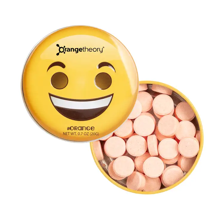 Boîte émoji sourire avec menthes à l’orange